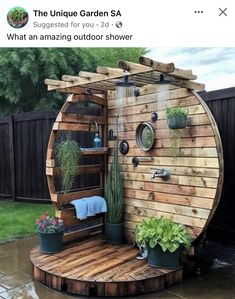 an outdoor shower in the shape of a barrel with succulents and cacti