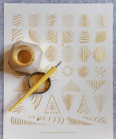 a roll of gold foil sitting on top of a piece of paper next to a cup of coffee