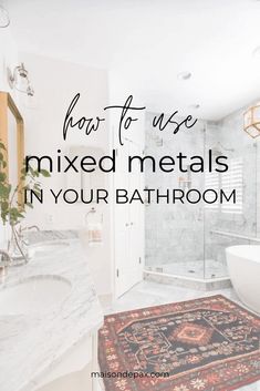 a bathroom with marble counter tops and a rug that says how to use mixed metals in your bathroom