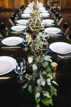 a long table with plates and place settings