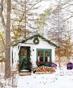 an instagram photo of a small white cabin in the woods with christmas decorations on it