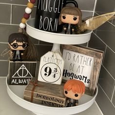 some harry potter figurines are on a shelf