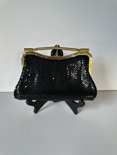 A lovely vintage black and white handbag in the style of Whiting and Davis from the 1960s or 70s. Honeycomb aluminium mesh gold evening bag, that you can wear as a clutch or as a shoulder bag. There is one zippered pocket inside.  The black tone strap is concealable or removable. The inside fabric lining is black.  The tag is marked "Aluminum Mesh Metal, Made in Hong Kong". Approximate measurements: 6" high 8 3/8" wide 2" deep Strap drop is 18" It is in very good vintage condition.  Please feel Retro Gold Shoulder Bag For Evening, Retro Black Evening Bag, Gold Retro Shoulder Bag For Evening, Retro Black Bags For Vintage Events, Vintage Party Shoulder Bag With Detachable Handle, Vintage Shoulder Bag With Detachable Handle For Party, Retro Vintage Black Evening Bag, Black Retro Bag For Party, Retro Handheld Shoulder Bag For Party