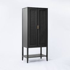 a tall black cabinet sitting on top of a white floor