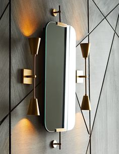 a wall mounted mirror with three lights on the side and one light on the other