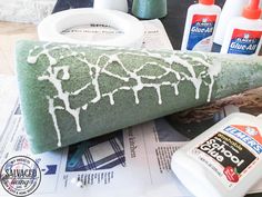 a baseball bat cake sitting on top of a table next to glue and other items