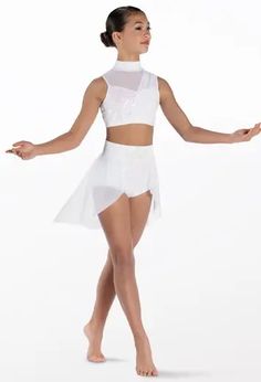 a woman in a white leotard and skirt is standing with her arms outstretched