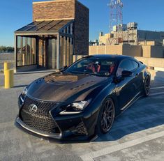 a black sports car parked in front of a building