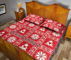 a bed with red and white snowflakes on it