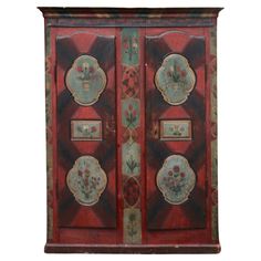 an old wooden cabinet with floral designs painted on it