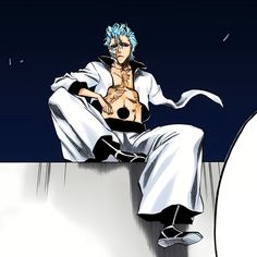 a man with blue hair sitting on top of a wall