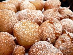 powdered sugar covered pastries on a white plate