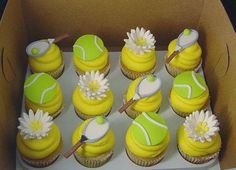 a box filled with cupcakes decorated like tennis balls and racquets