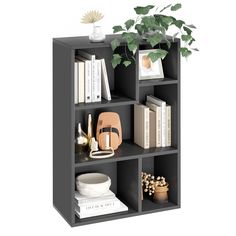 a book shelf with books, plants and other items on it in front of a white background