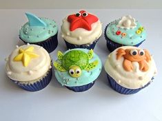 there are many cupcakes that have been decorated with sea animals and fish on them