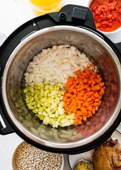 the ingredients for this meal are mixed in an instant pressure cooker, including onions, carrots, and other vegetables