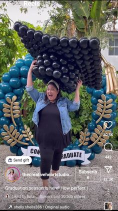 a woman is holding up balloons in front of her head and the words congratulations written on it