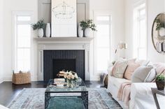 a living room filled with furniture and a fire place in the middle of a room