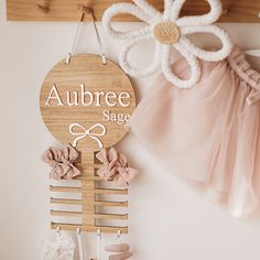 a wooden sign that says aubree sage hanging on a wall next to other items