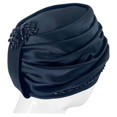 Chic 1960s YVES SAINT LAURENT black silk / satin beaded turban hat ! Features hand-sewn black beads around the brim, and on the band on the back. Couture quality, with exceptional attention to details. Can easily be dressed up or down. Pair with jeans and a tee, or a dress. The possibilities are endless with this collectors piece. In great condition Made in France Measurements: 21.75 inches inner circumference Fashion 1950s, Turban Hat, Hats For Sale, Vintage 60s, Black Silk, Black Beads, Silk Satin, Yves Saint Laurent, Hand Sewing