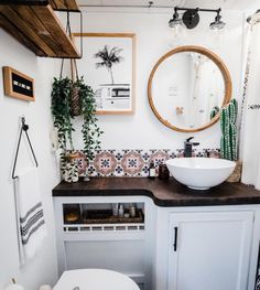 a bathroom with a toilet, sink and mirror