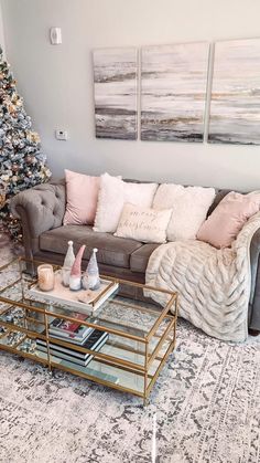 a living room filled with furniture and a christmas tree in front of the couches