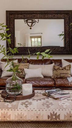 a living room filled with furniture and a large mirror