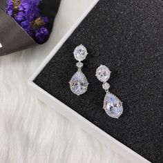 "These stud bridal earrings are stunning for bridal occasions whether you want a vintage or classic look. These beauties are designed with encrusted crystals and high quality AAA+ cubic zirconia that glistens on the ear. They come in a sparkling silver, gold or rose gold finish to give an elegant look. These gorgeous earrings will be carefully wrapped and arrive in a logo gift box. Visit my shop for care instructions and more bridal accessories ➔ https://www.etsy.com/shop/BlushandIvoryStudio Mea Diamond Clip-on Earrings With Sparkling Stones For Wedding, Wedding Clip-on Earrings In Diamond White Cubic Zirconia, Classic Crystal Bridal Earrings For Evening, Elegant Crystal Bridal Earrings Pear-shaped, Elegant Crystal Pear-shaped Bridal Earrings, Classic Evening Bridal Earrings In Crystal, Elegant Pear-shaped Crystal Bridal Earrings, Silver Drop Clip-on Earrings For Wedding, Crystal Drop Cluster Earrings For Wedding