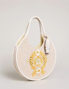 Don't be a square! Our fun, round Gina Hobo features beautiful retro 70s inspired floral vine embroidery and a Napa leather tassel fob. The curved leather shoulder strap fits snuggly on your shoulder or arm and opens to two slip pockets and one zip pocket. Gina is functionality and unique style all in one! DETAILS Soft, durable Top Grain Napa Leather Accents Zipper closure Top Grain Napa Leather Tassel Attached Custom cotton stripe interior features: two slip pockets and one zip pocket W: 13.5 in. H: 12.85 in. D: 2.5 in. Handle Drop: 8 in. Bohemian Floral Embroidery Shoulder Bag For Spring, Vine Embroidery, Lowcountry Style, Expensive Bag, Summer Holiday Outfits, Stylish Handbags, Kate Middleton Style, Shades Of Beige, Leather Accents