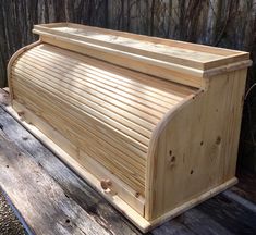 a wooden box sitting on top of a wooden bench