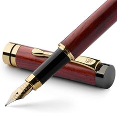 a wooden pen with gold trim and black nib