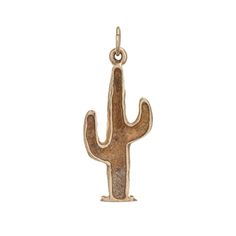 a small gold cactus charm on a white background