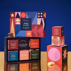 an assortment of colorful boxes and cookies on a table