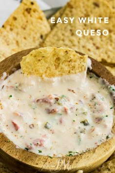 a wooden bowl filled with white quesadilla dip next to tortilla chips