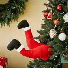 a christmas tree decorated with stockings and ornaments, including a santa clause ornament