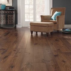 a living room with hardwood floors and a chair