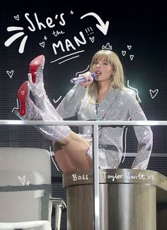 a woman in silver dress and red high heels on stage with her legs up to the side