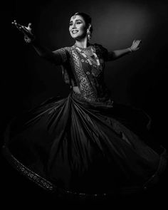 a woman in a black and white photo is dancing