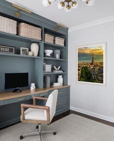 a room with a desk, chair and television on the wall in front of it