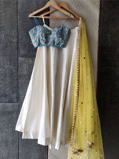 This classic ivory raw silk skirt with ivory thread and sequin work bustier is paired with powder pink tulle dupatta with sequin highlight and scallop edging. Fitted Raw Silk Dupatta With Pearl Embroidery, Fitted White Raw Silk Choli, White Tissue Silk Choli For Party, White Raw Silk Sharara For Party, Fitted White Raw Silk Anarkali Set, White Tissue Silk Sharara For Party, White Silk Choli For Party, White Silk Party Choli, Cream Raw Silk Fitted Lehenga