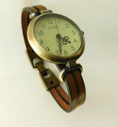 Leather watch for women, retro minimalist style. The watch face is aged bronze finish, round, 1.25 inches diameter, greenish quadrant with numerals and three needles. The band is made with two pieces of high quality European leather and will be custom size to fit your wrist, please, select the measure of your wrist when you buy it. If the measure of your wrist is not in the list, please, send me a message. The clasp is fold-over style also aged bronze finish. Comes in a gift box with an spare ba Vintage Everyday Watches, Everyday Vintage Watch, Vintage Adjustable Watch Accessories With Analog Display, Vintage Watch Accessories With Analog Display For Everyday Use, Vintage Brown Watch With Metal Dial, Retro Minimalist, Aged Bronze, Watch For Women, Women Wrist Watch