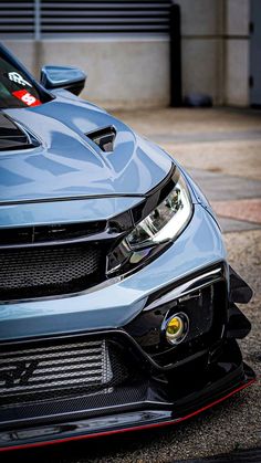 the front end of a blue sports car