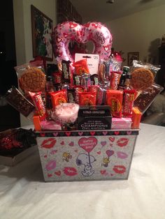 a valentine's day gift basket with cookies and candy