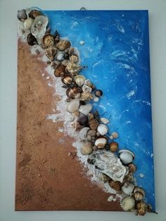 an image of seashells and sand on the beach