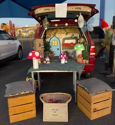 the back end of a van with mushrooms and plants on it's hood, parked in a parking lot