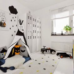 a child's bedroom with a teepee tent and toys