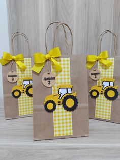 three brown bags with yellow and white designs on them, one has a small tractor