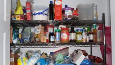 the pantry shelves are full of food and condiments