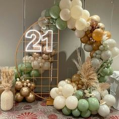 a table topped with balloons and a number twenty sign next to a basket filled with pineapples