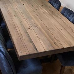 a large wooden table with blue chairs around it